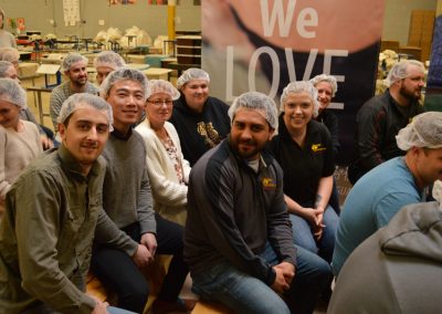 Crawford Roofing Employees volunteering with Feed My Starving Children Through Rabine Group Foundation