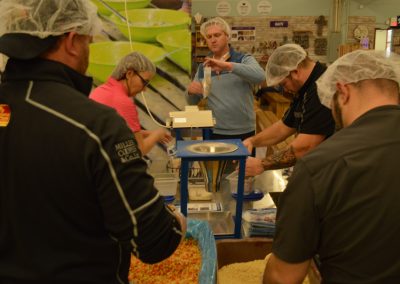 Crawford Roofing Employees volunteering with Feed My Starving Children Through Rabine Group Foundation