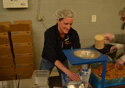 Crawford Roofing Employees volunteering with Feed My Starving Children Through Rabine Group Foundation