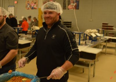 Crawford Roofing Employees volunteering with Feed My Starving Children Through Rabine Group Foundation