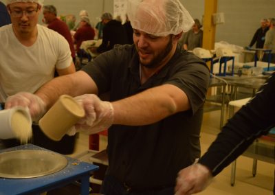 Crawford Roofing Employees volunteering with Feed My Starving Children Through Rabine Group Foundation