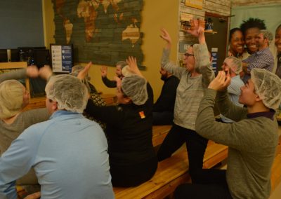 Crawford Roofing Employees volunteering with Feed My Starving Children Through Rabine Group Foundation